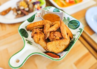 Fried Chicken wing dusted with flour and deep-fried in hot oil. With tender and juicy .
