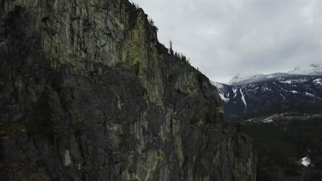 Aerial Flight by Canadian Rocky Mountain Landscape in British Columbia, Canada. Cloudy Sky. Spring Season