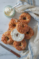 home made whole grain Bagels with cheese on a table
