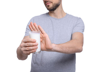 Man with glass of milk suffering from lactose intolerance on white background, closeup