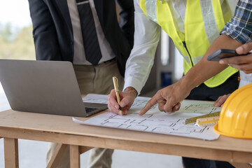 Architect or engineer are designing house, modifying plan, creating construction project and addition according to customer requirement.