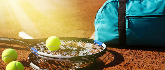 Tennis balls, rackets and bag on clay court, banner design
