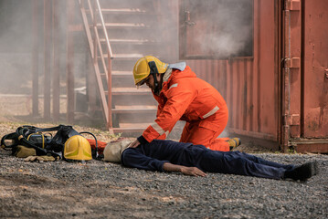 The firefighters applied their training and experience to perform life saving measures on the unconscious victim, Saving people.