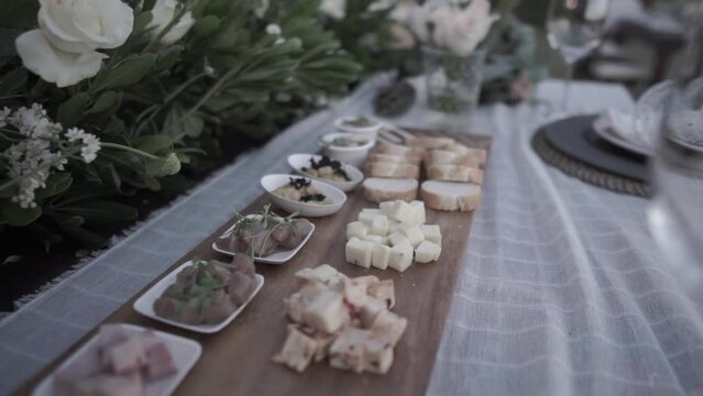 Slow revealing shot of a charcuterie board on a table at a wedding reception
