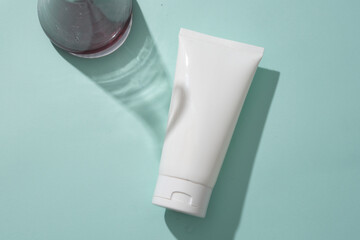 A white plastic tube on blue background with erlenmeyer flask filled purple liquid. Mockup scene...