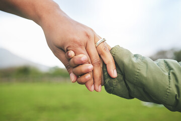 Closeup, mother and child holding hands in park, morning walk and bonding with trust, support and...