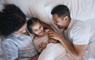 Mom, dad and child laugh in a bedroom bed in the morning at family home with bonding. Tickle,...