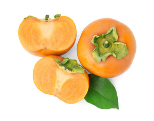 Whole and cut delicious ripe juicy persimmons with green leaf on white background, top view