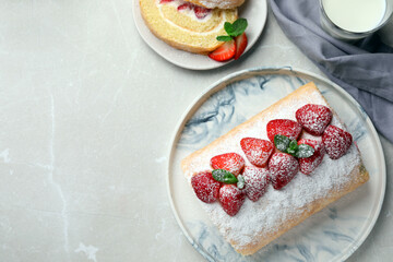 Delicious cake roll with strawberries and milk on light gray table, flat lay. Space for text