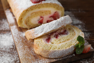 Pieces of delicious cake roll with strawberries and cream on table, closeup
