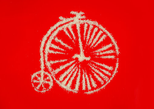 cheese bike penny-farthing on red background