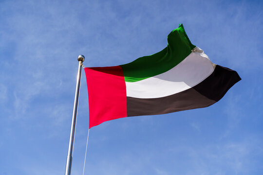 Flag of the UAE on background of the sky in Dubai. Arab Emirates, Persian Gulf.