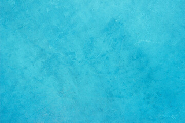 Blue light concrete texture for background in summer wallpaper. Cyan cement colour sand wall of tone vintage. Abstract teal dark color.	