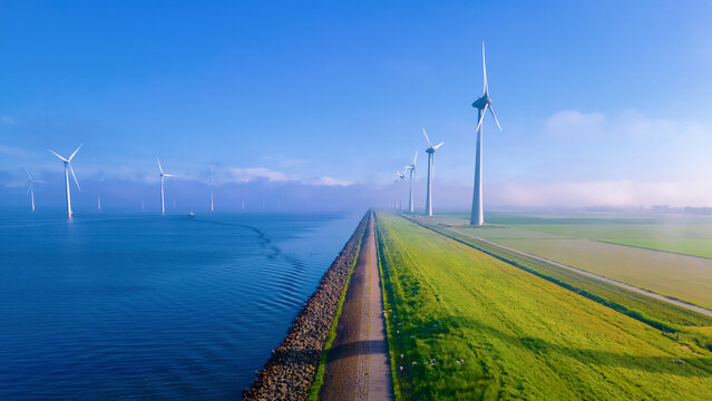  windmill park with a blue sky on a sunny day in the Netherlands, biggest windmill park in the ocean