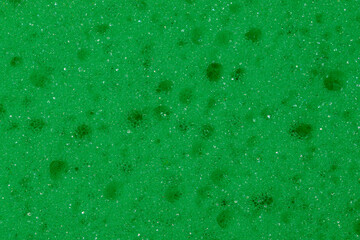 Tapeta zielone tło  z gąbki do naczyń. W zbliżeniu makro z dziurkami. 