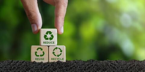 concept, reduce, reuse, recycle, recycle symbol Hand placed wooden block with green recycle icon....