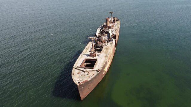 rusty stranded cargo ship, wrecked