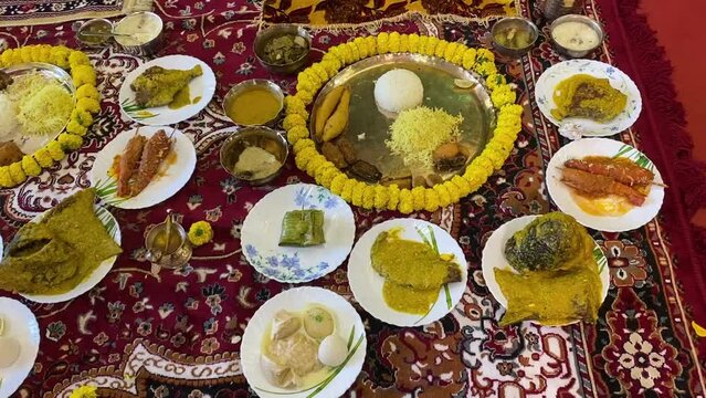 Traditional Bengali dishes for rice ceremony. A plate full of khichdi, pulao, curry, payesh and some fries.