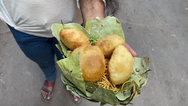 Fresh Club Kachori held in a leave plate with sev puri in road side in Kolkata.