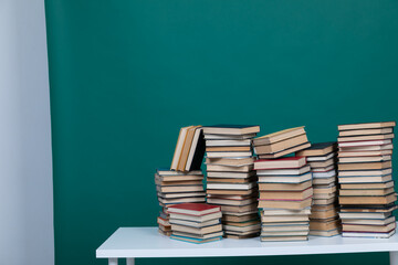stack of books on a green background learning library learning science