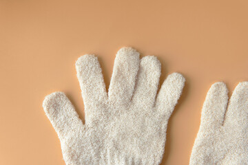 Top view close-up Nylon Beige or cream color women exfoliating gloves for refresh soft smooth or...