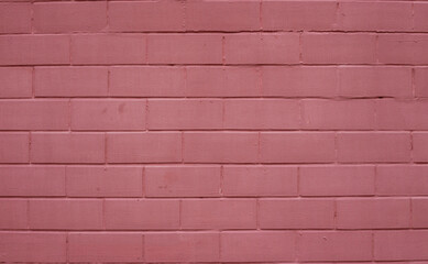 The surface of a brick yellow-and-red wall close-up.