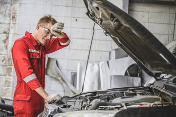Tired exhausted mechanic male staff fatigue worker work in hot workplace car service problem hard...