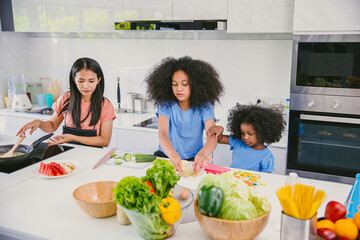 Happy family cooking healthy food together at home kitchen holiday activity.