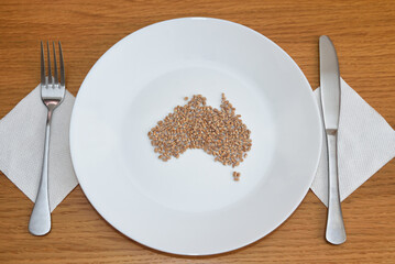 Wheat on a plate laid out in the shape of a map of Australia. Food concept