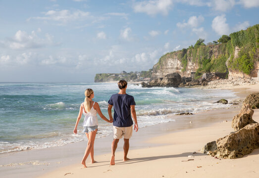 Young couple walking together at beach