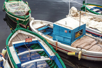 Fototapeta na wymiar Small Fishing boats in port of Syracuse town, Sicily Island, Italy