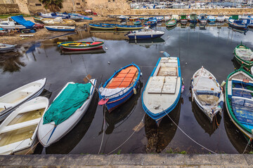 Fototapeta na wymiar Fishing boats in port of Syracuse town, Sicily, Italy