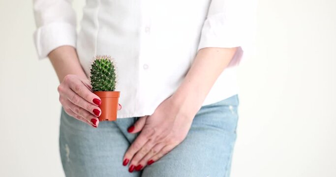 Woman holding cactus and covering genitals with disease with hand closeup 4k movie slow motion. Sexually transmitted infections symptoms and treatment concept