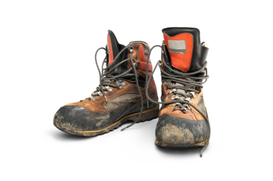 A pair of well worn old leather hiking boots used to protect your feet when walking in the mountains isolated against a transparent background.