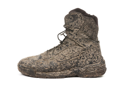 Black shoe, covered in mud