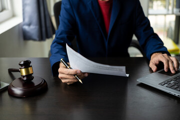 Businessmen and lawyers discuss contract documents, treaties of law, sign business contracts. Male...