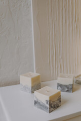 Wax candles with a concrete base in the interior, an advertising shoot
