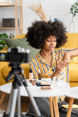 Cheerful black woman recording video. skin care
