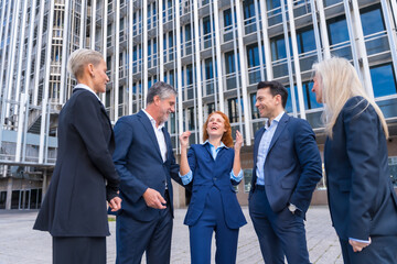 Group of Adult Executives Laughing and Chatting in a Business District