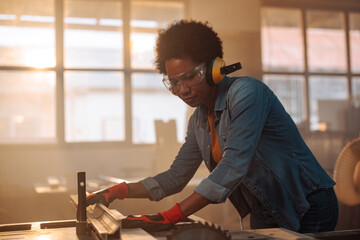 Female carpenter using power tools.