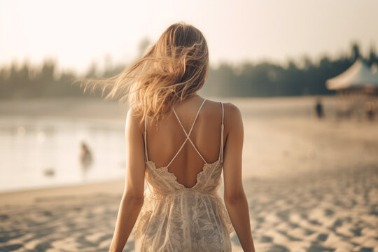 beautiful girl in a dress walks along the sandy beach back view generative ai