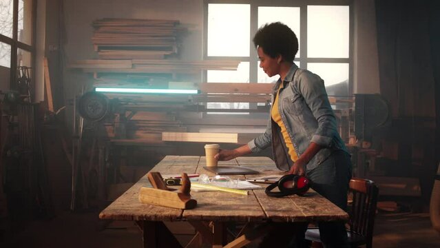 African American woman in wood workshop.