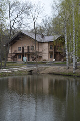 Fototapeta na wymiar A house in the woods by the lake