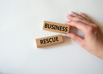 Business rescue symbol. Wooden blocks with words Business rescue. Businessman hand. Beautiful white background. Business and Business rescue concept. Copy space.