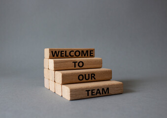 Welcome to our team symbol. Concept words Welcome to our team on wooden blocks. Beautiful grey...