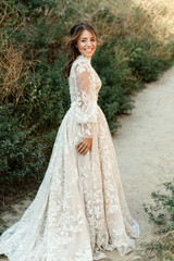 portrait of a contented young bride outdoors in the summer. medium plan. bride on a walk