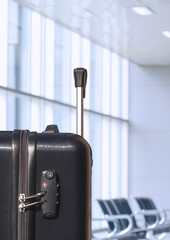 Focus at Black luggage bag with TSA accepted security lock in passenger rest area at terminal...