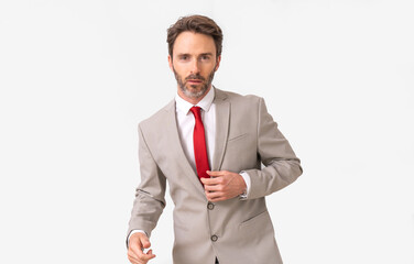 Handsome male model posing wearing a silver suit and a red tie.