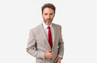 Handsome male model posing wearing a silver suit and a red tie.
