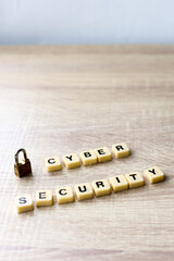 Cyber security lettering with padlock on wooden table